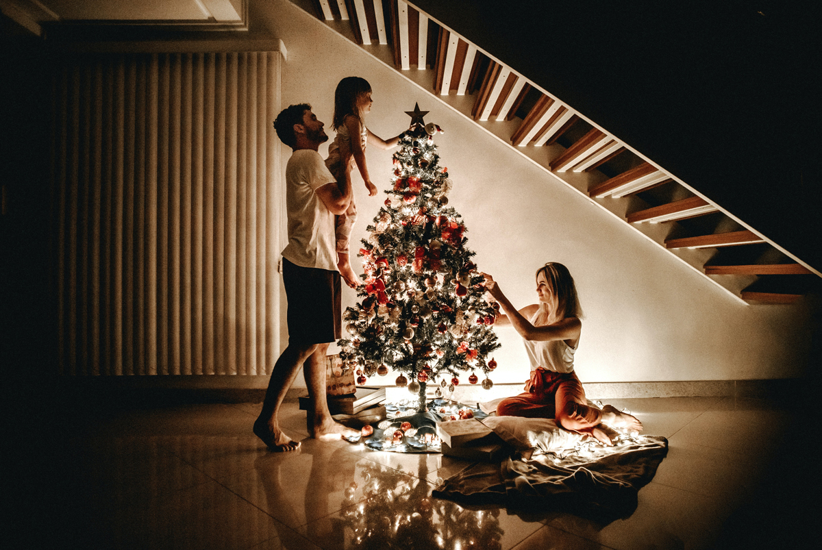 family decorating holiday tree