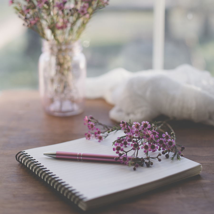 pen, notebook, and flowers