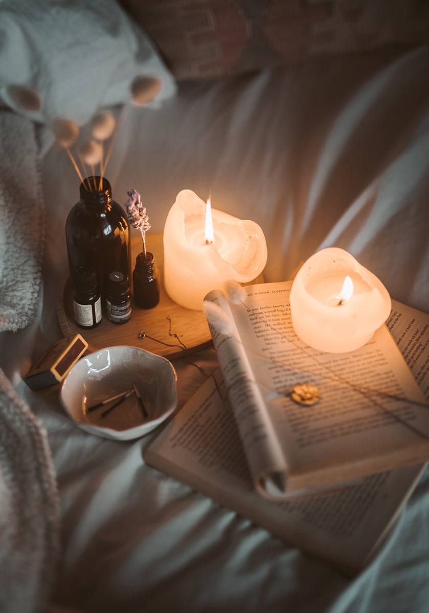 candles and books on bed