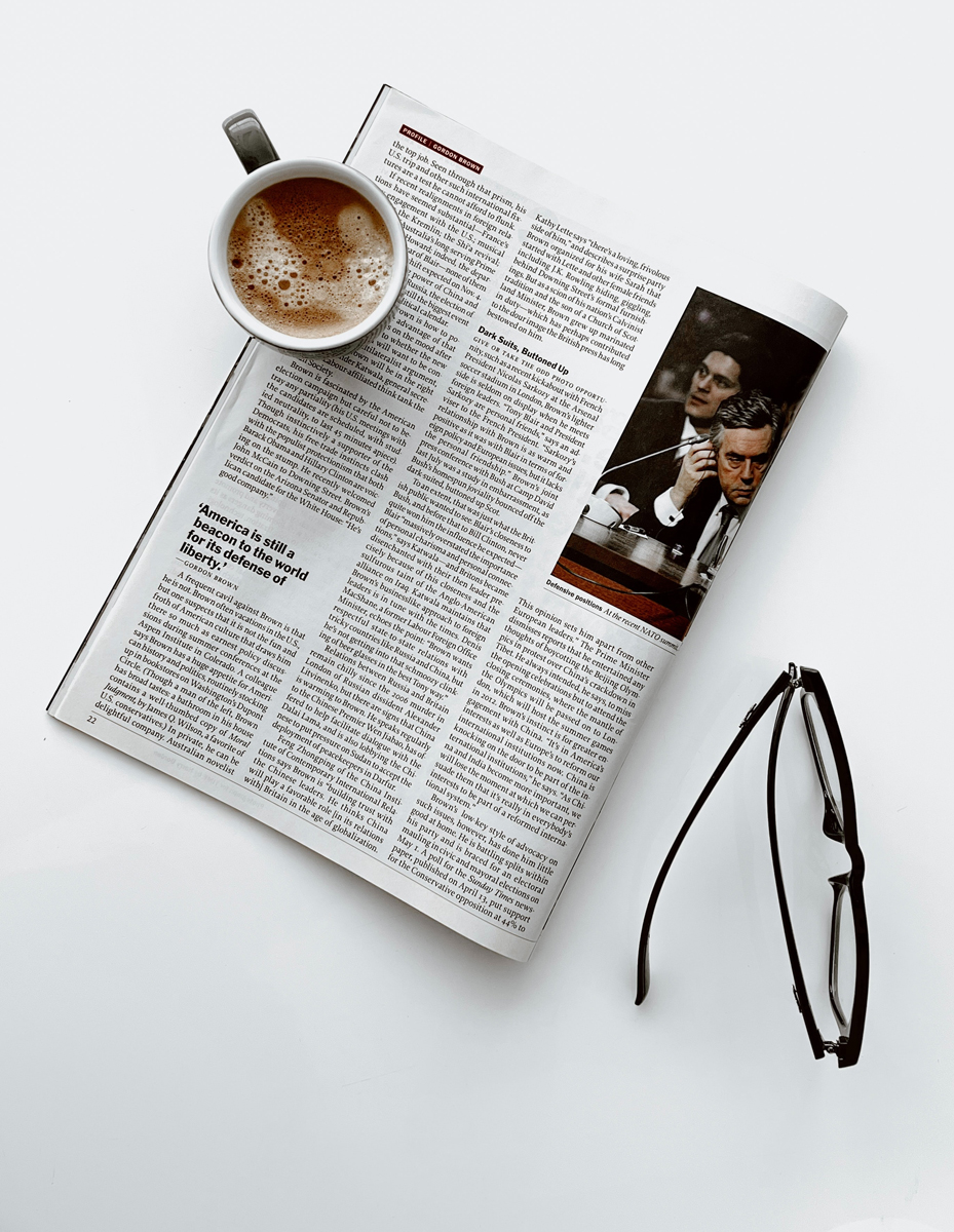newspaper with coffee and glasses