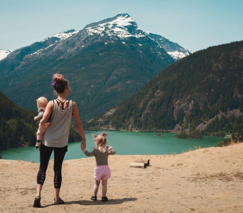 Mother holding hands with her kids looking at the mountains