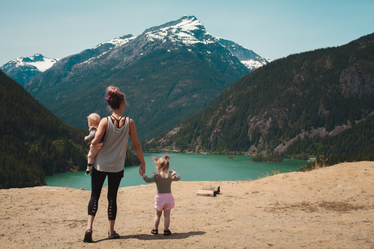 Mother holding hands with her kids looking at the mountains