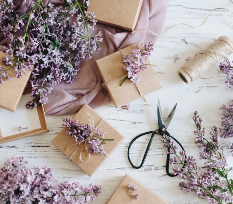 Lavender flowers mixing in with parchment-paper wrapped gifts