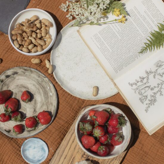 bowls of fruit, peanuts, and a book