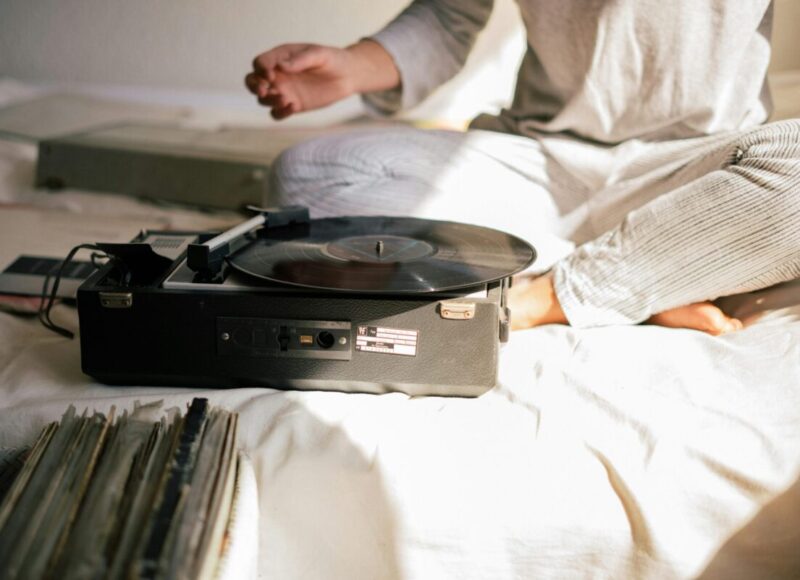 person sitting in front of a record player