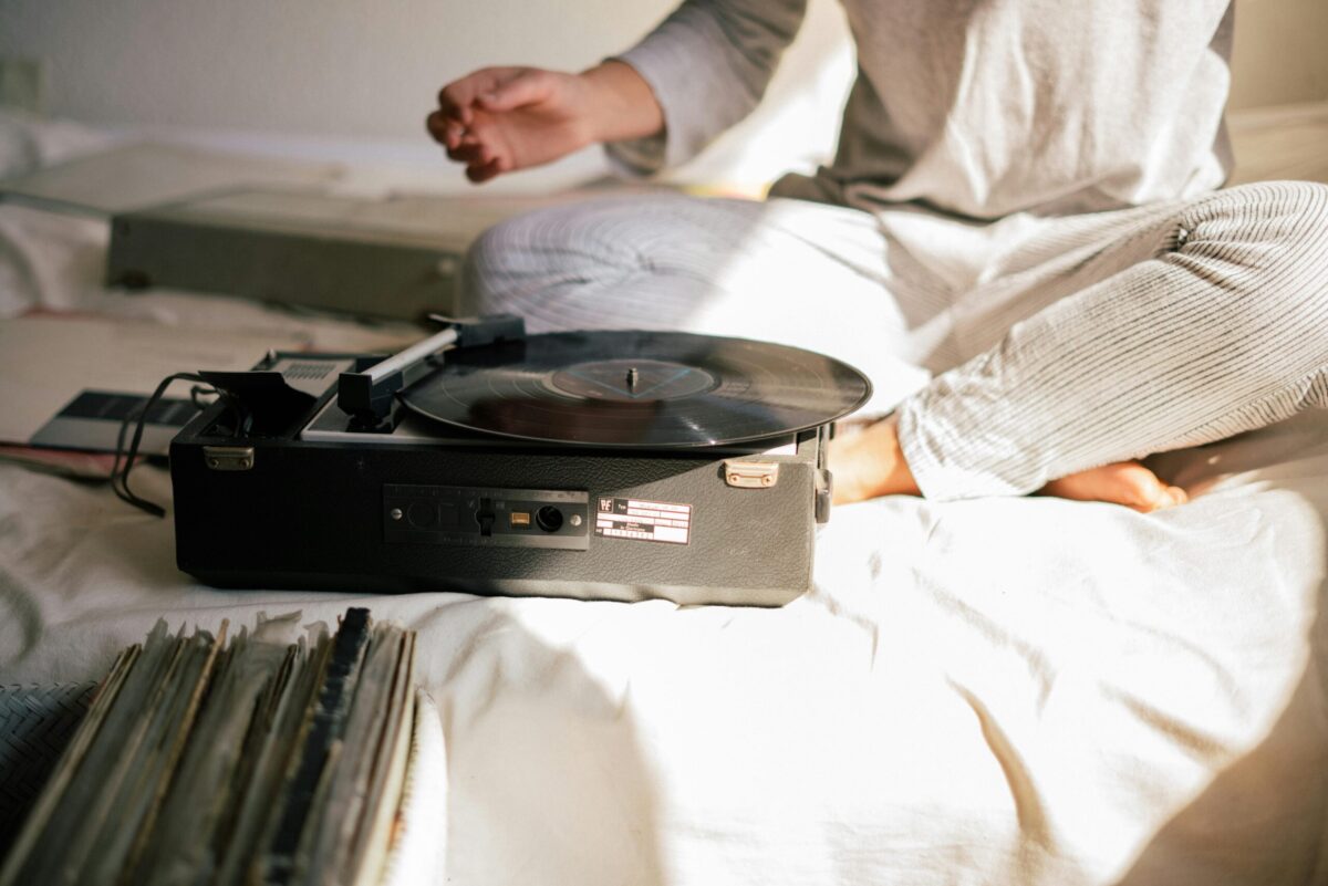 person sitting in front of a record player